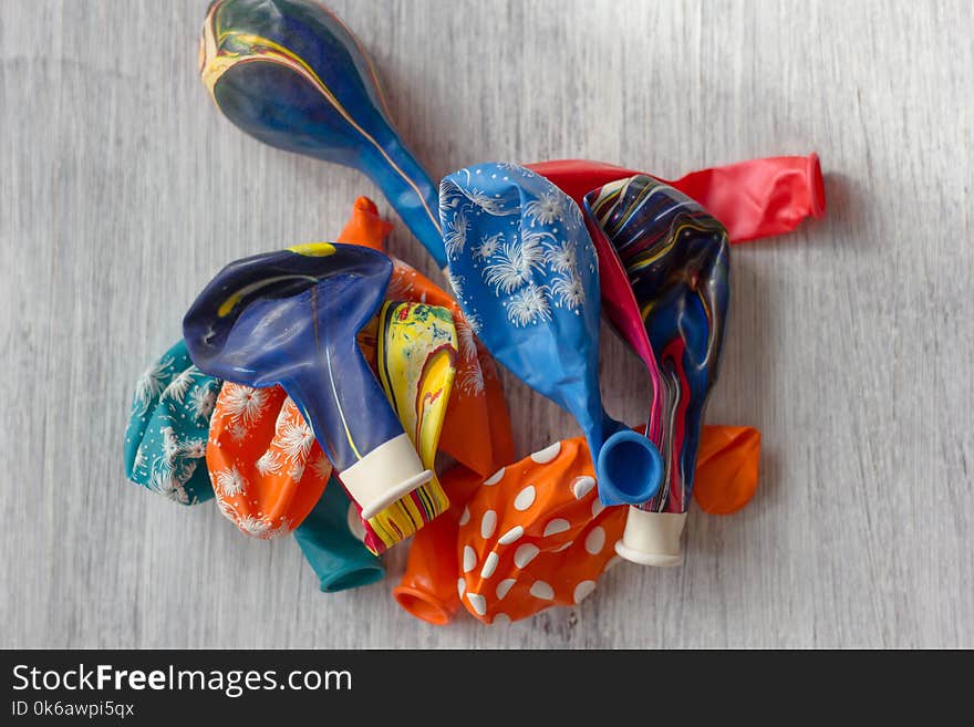 Empty Balloons On A White Table. Balloons Without Air.