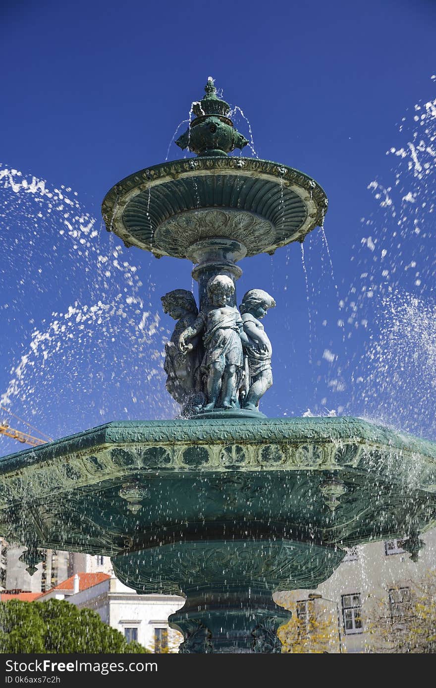 Baroque style fountain in Rossio Square Lisbon