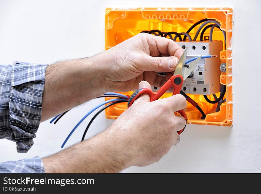 Electrician technician at work on a residential electric panel