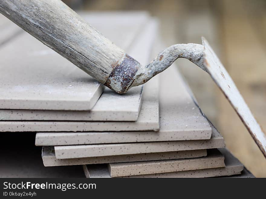 Laying and cutting tiles. Tools and building materials at a working position. Tiles for industrial and technical applications. Material Gres.