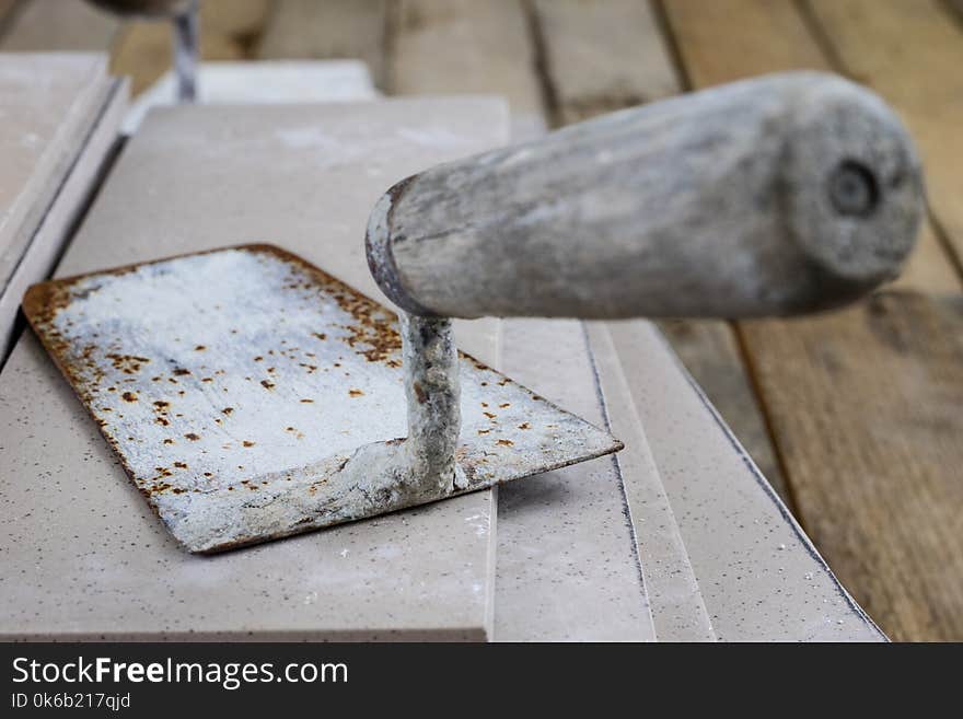 Laying and cutting tiles. Tools and building materials at a working position. Tiles for industrial and technical applications. Material Gres.