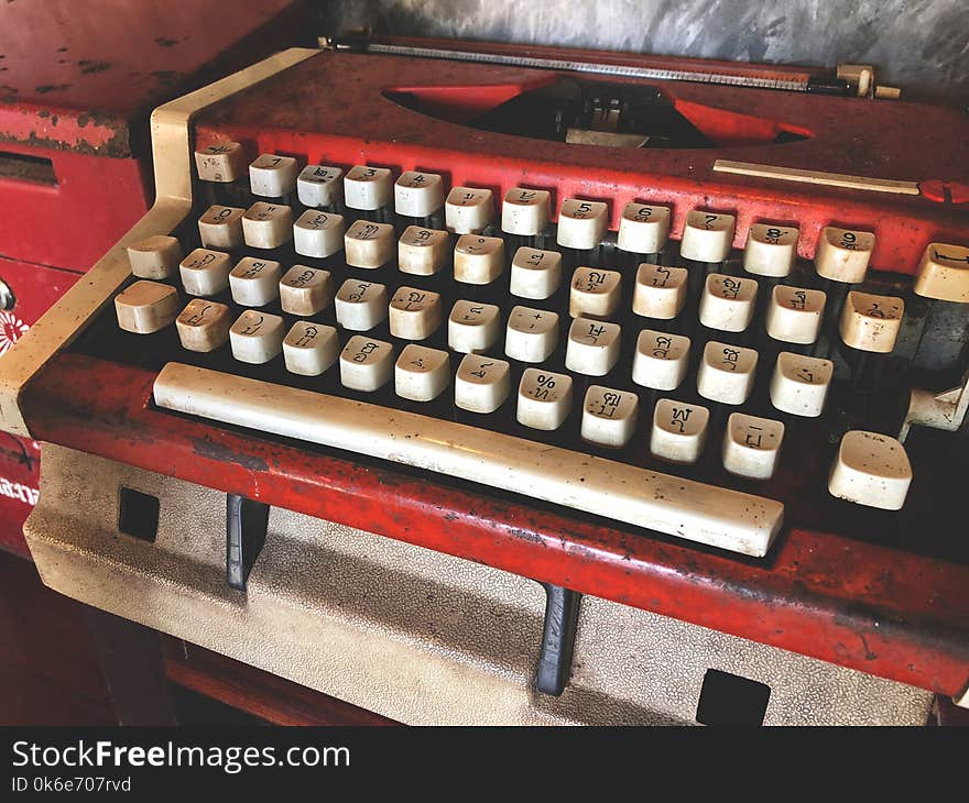 Old red and white typewriter.Vintage type word. Back to the basic.