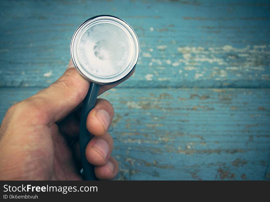 The hand holding a stethoscope