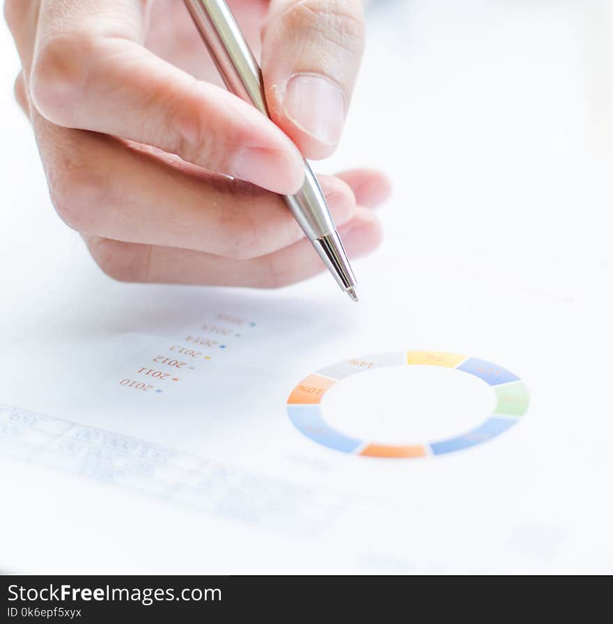 Woman hand with pen and business report