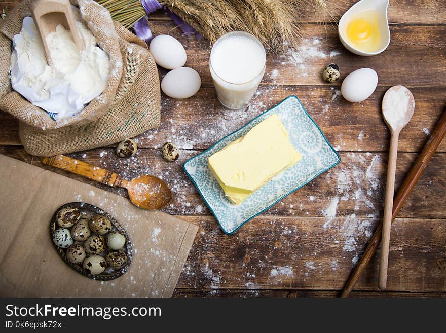 Natural organic ingredients to make cookies as dough, flour, eggs, butter,milk on wooden background