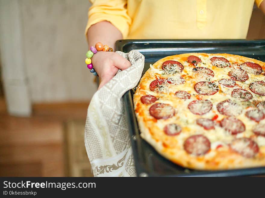 The girl is cooking pizza