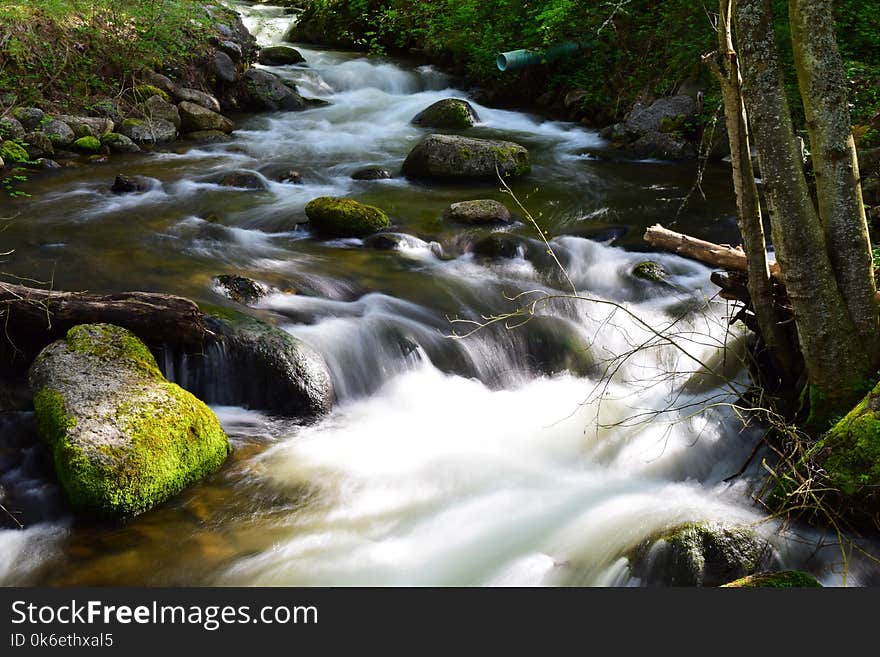 Photo of rapids and rocks along a little creek in the state of Oregon. Photo of rapids and rocks along a little creek in the state of Oregon