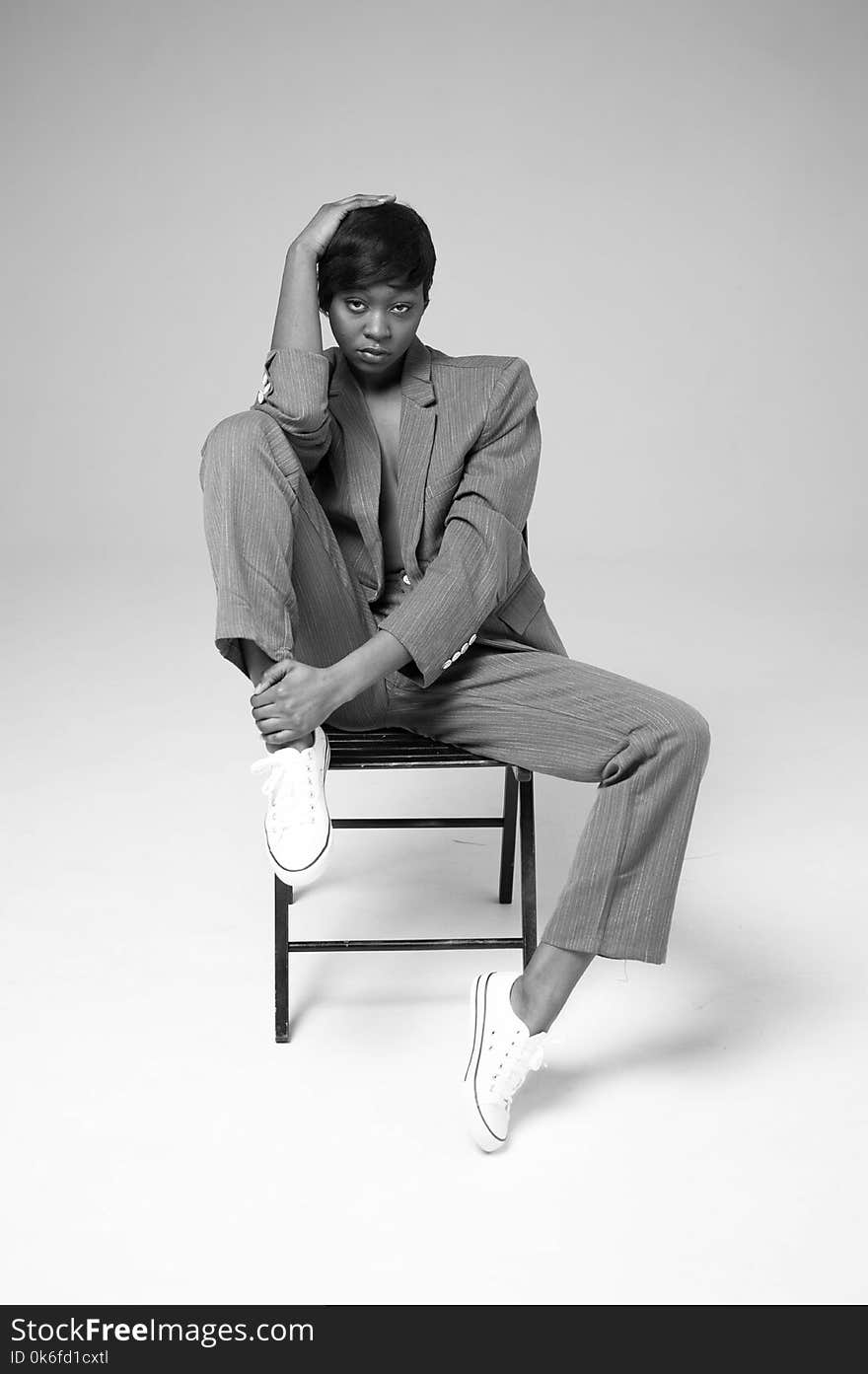 Woman Sitting On Metal Chair