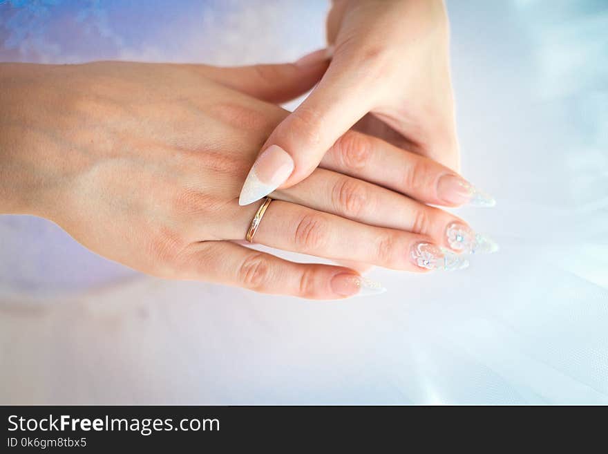 Bride hands with wedding ring on fingers and beautiful nails