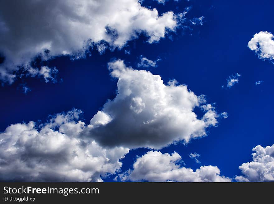 White clouds in the bright blue sky on sunny summer day