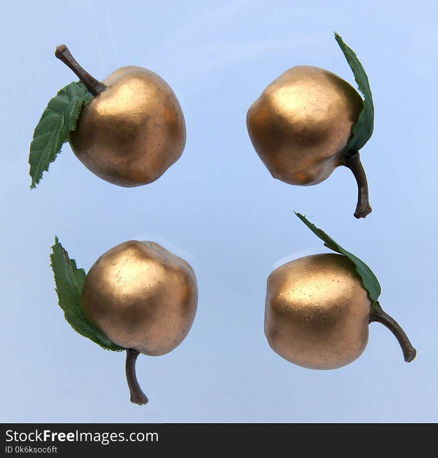 Golden apples isolated on gray background as a festive or christmas pattern. Golden apples isolated on gray background as a festive or christmas pattern