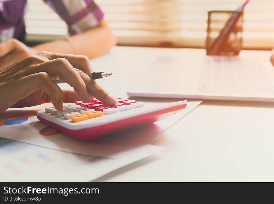 Close up woman calculate about cost and doing finance at office