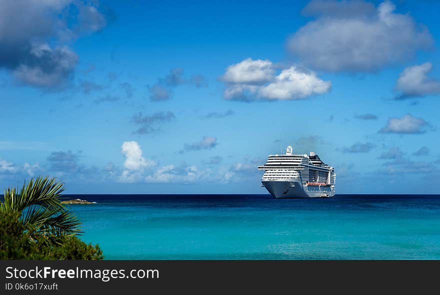 Cruise ship in crystal blue water with blue sky