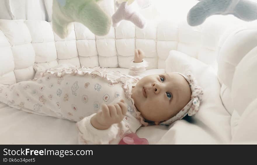 Adorable newborn baby girl in her cot