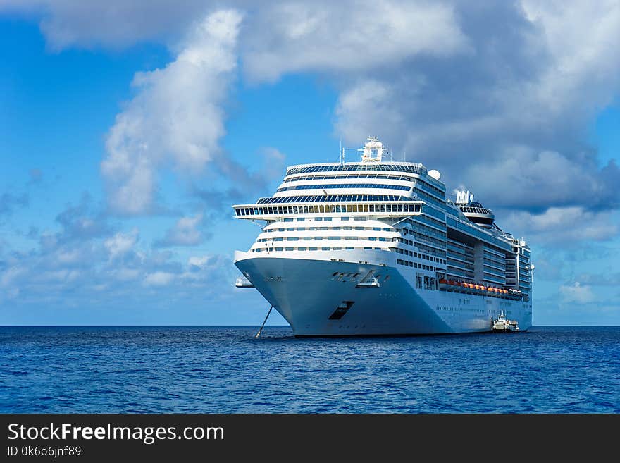 Cruise ship in crystal blue water with blue sky