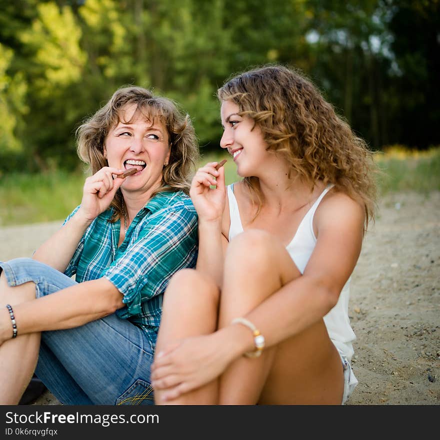 Mother and daughter enjoying chocolate bar