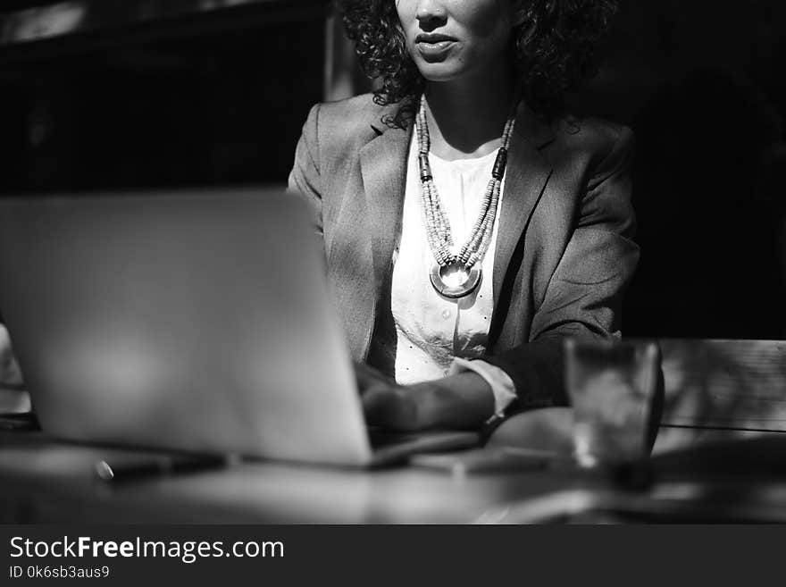 Grayscale Photo of Woman Using Her Laptop