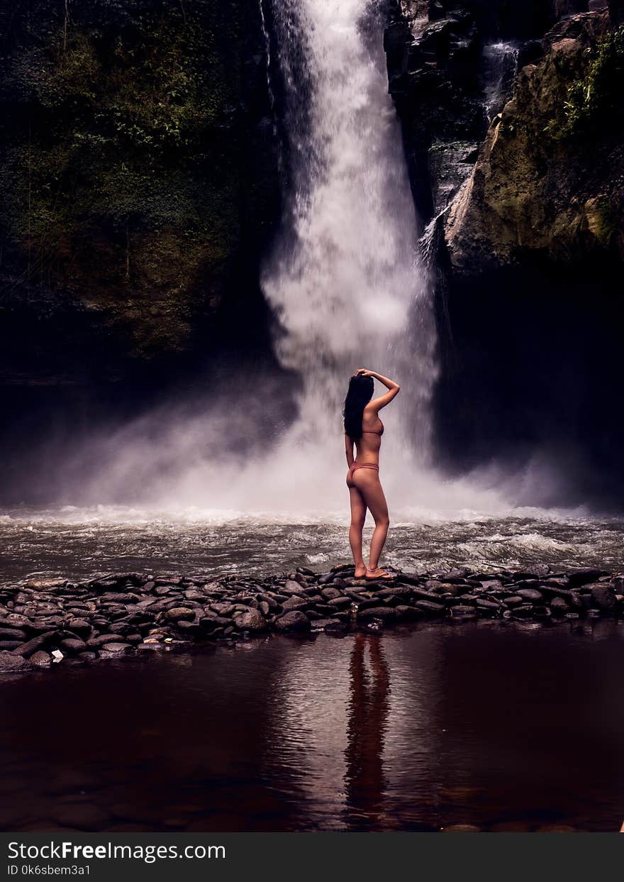 Photo of a Woman Wearing Bikini in Front of Waterfalls