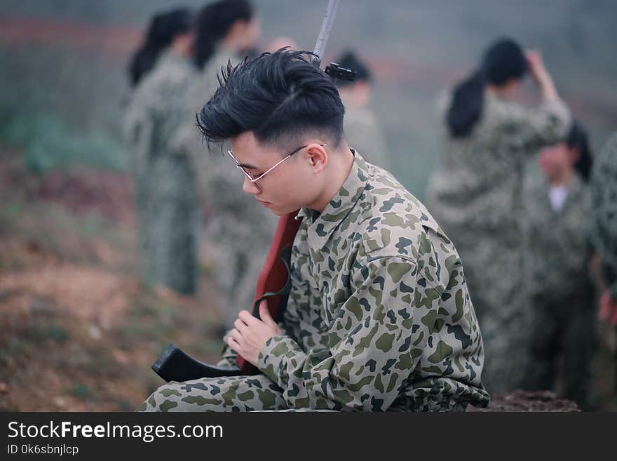 Man Wearing Sunglasses Holding Rifle