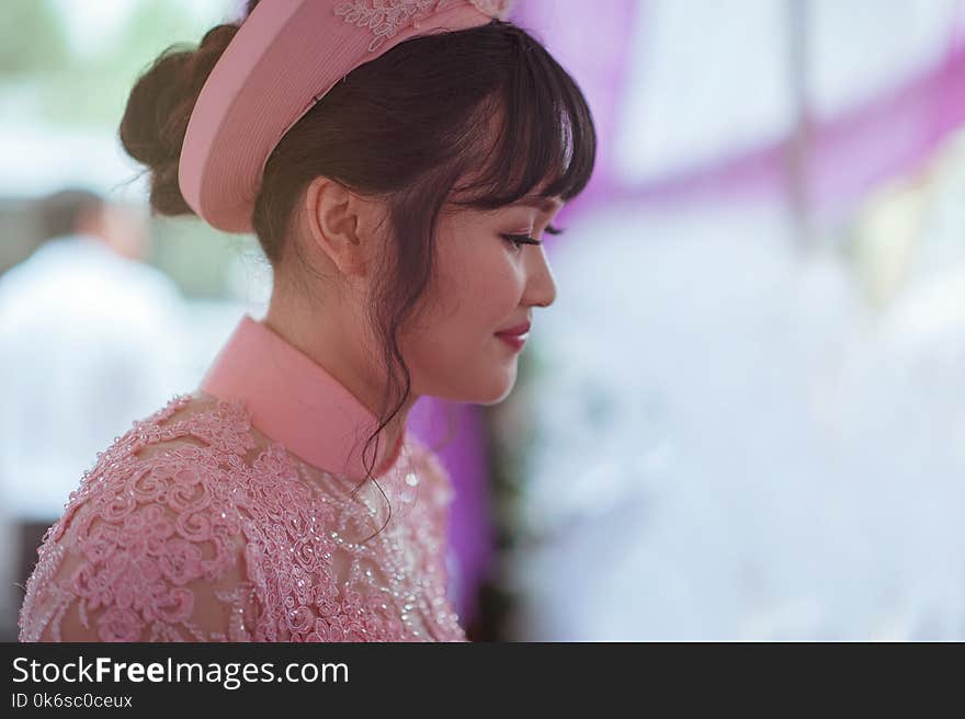 Person Taking Photo of Black Haired Woman in Pink Floral Dress in Tilt Shift Photography