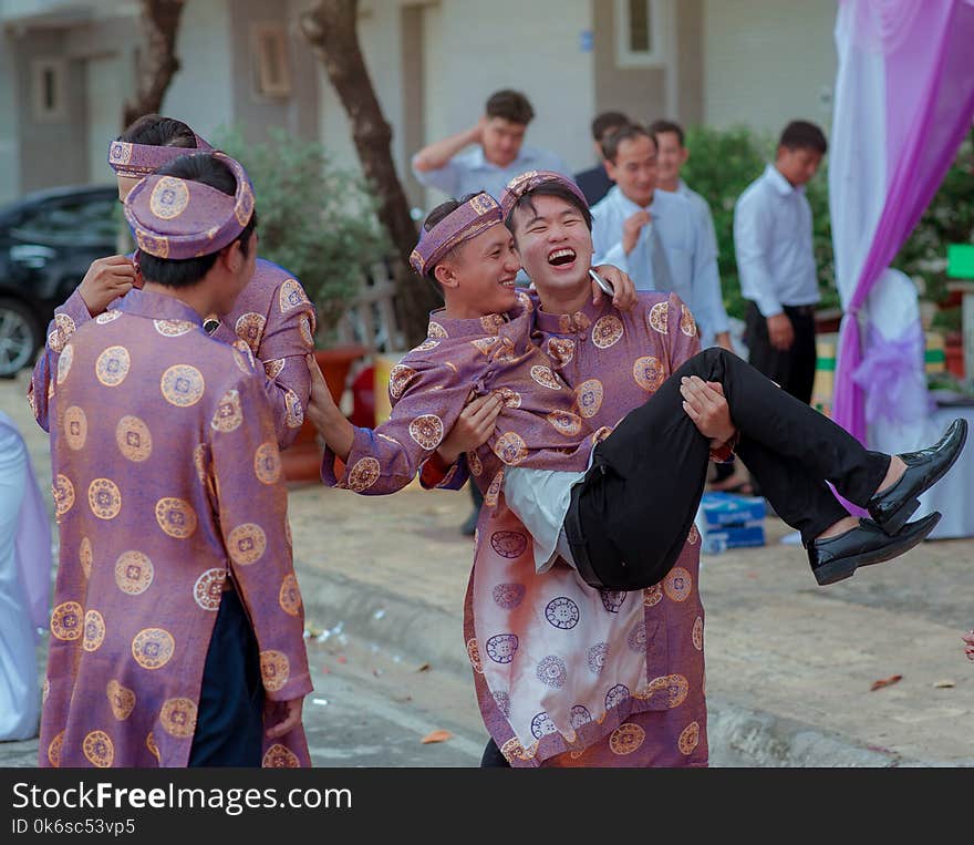 Several Men Wearing Purple-and-gold Traditional Dresses