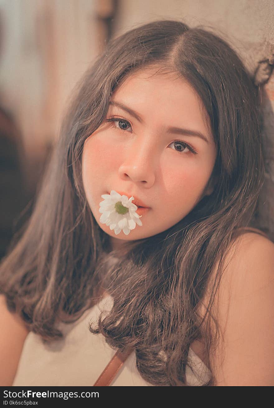 Woman Having a White Daisy on Her Mouth