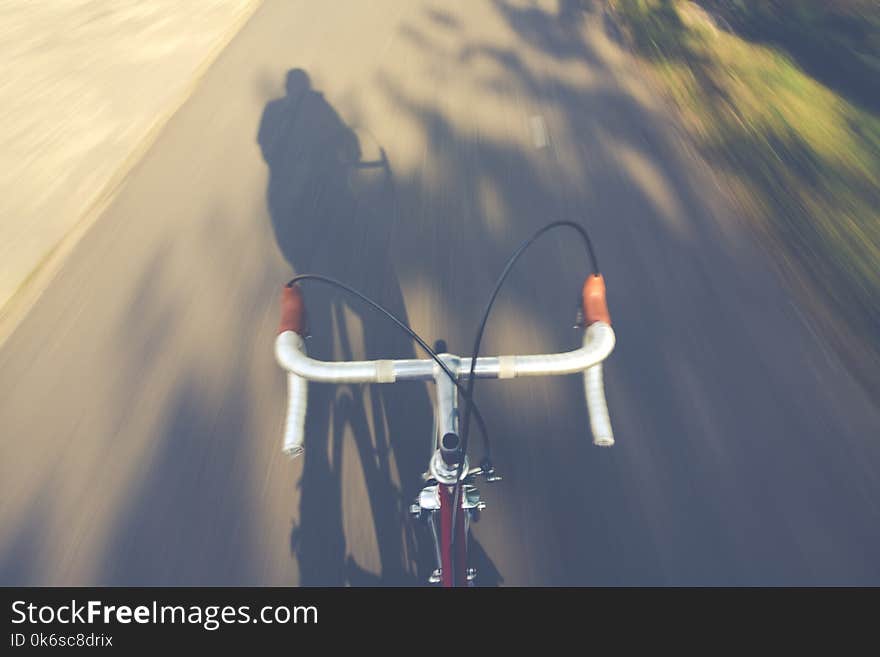 Timelapse Photography of a Person Riding a Road Bike