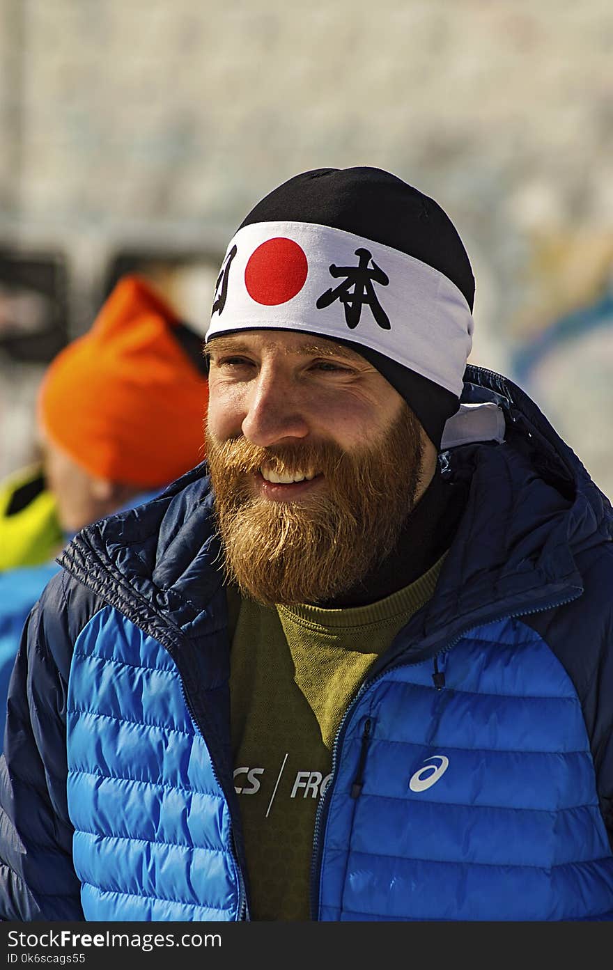 Smiling Man In Blue And Black Zip-up Bubble Jacket