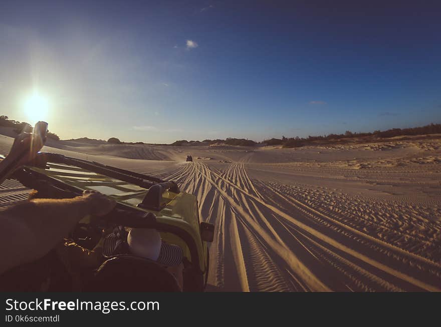 Person Riding Yellow Dune Buggy