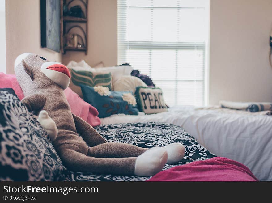 Sock Monkey Plush Toy On Bed