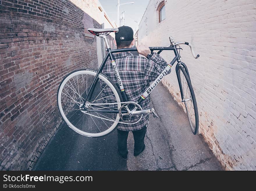 Man Carrying White And Black Bianchi Road Bike