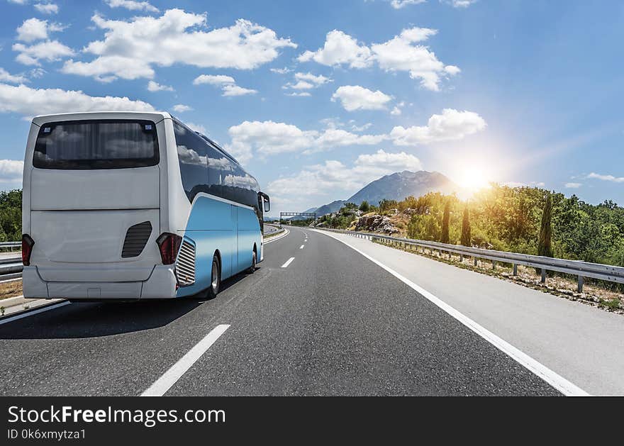 Bus rushes along the asphalt high-speed highway.