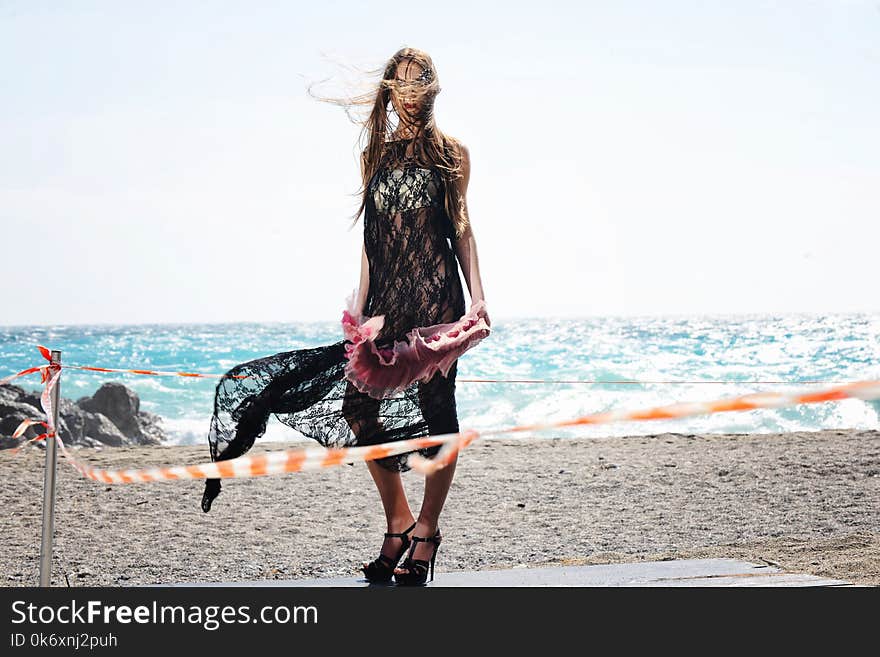 Beautiful girl in fashion outfit by the sea