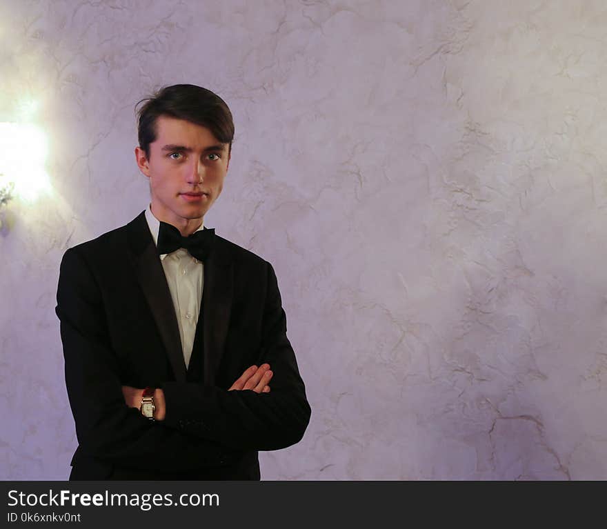 Handsome young guy in suit and bow tie