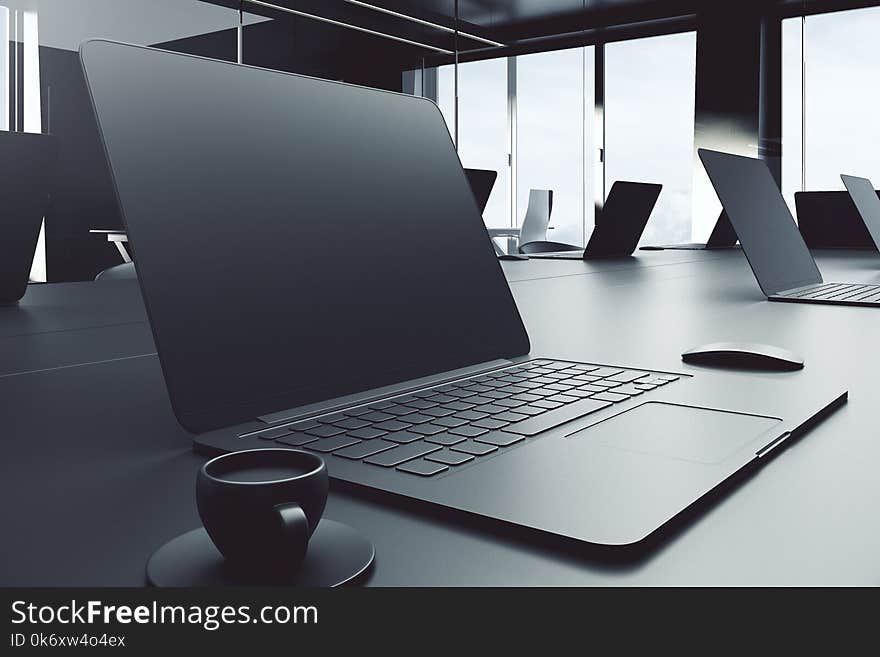 Side view of empty laptop placed on grey office desktop with coffee cup and other items. Mock up, 3D Rendering. Side view of empty laptop placed on grey office desktop with coffee cup and other items. Mock up, 3D Rendering