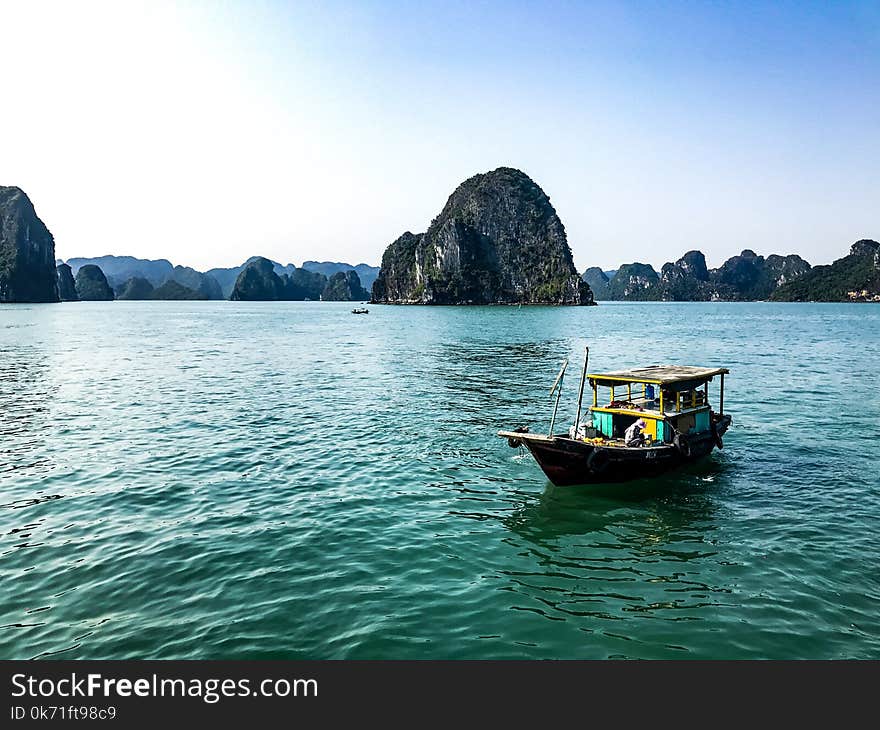 Brown Boat on Body of Water