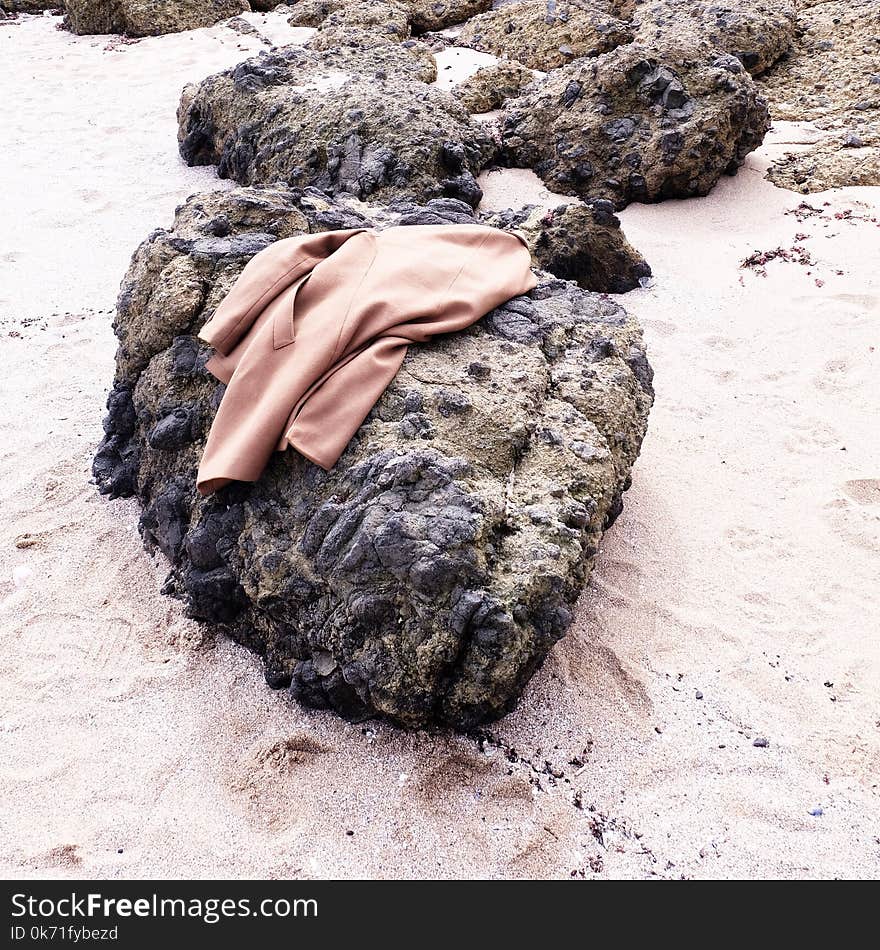 Brown Coat on Black Stone