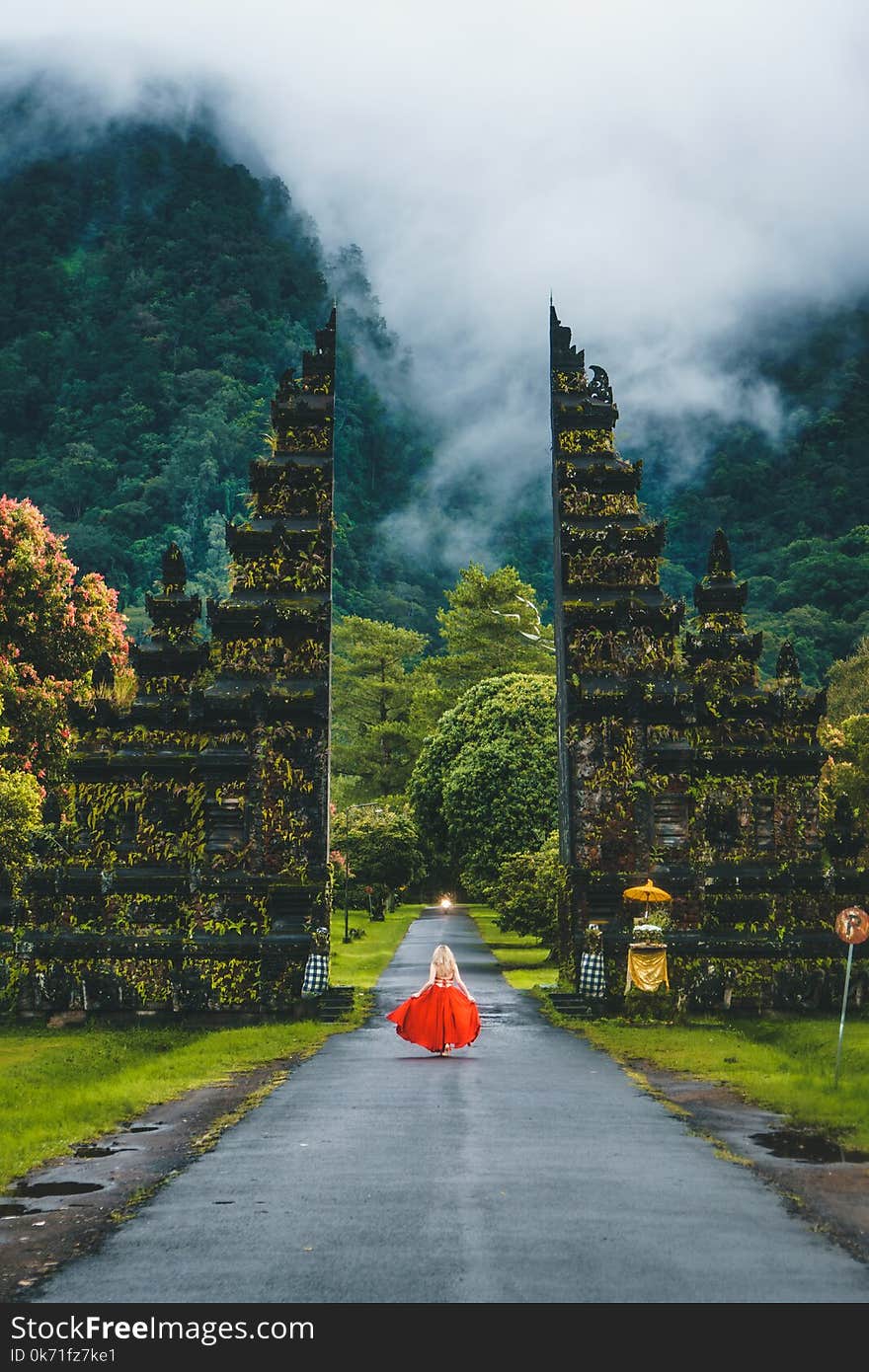 Woman in Red Dress Standing on Gray Road