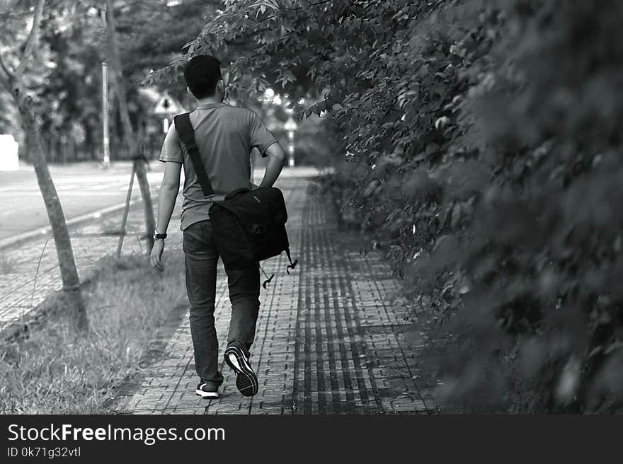 Man Wearing T-shirt; Pants; Crossbody Bag