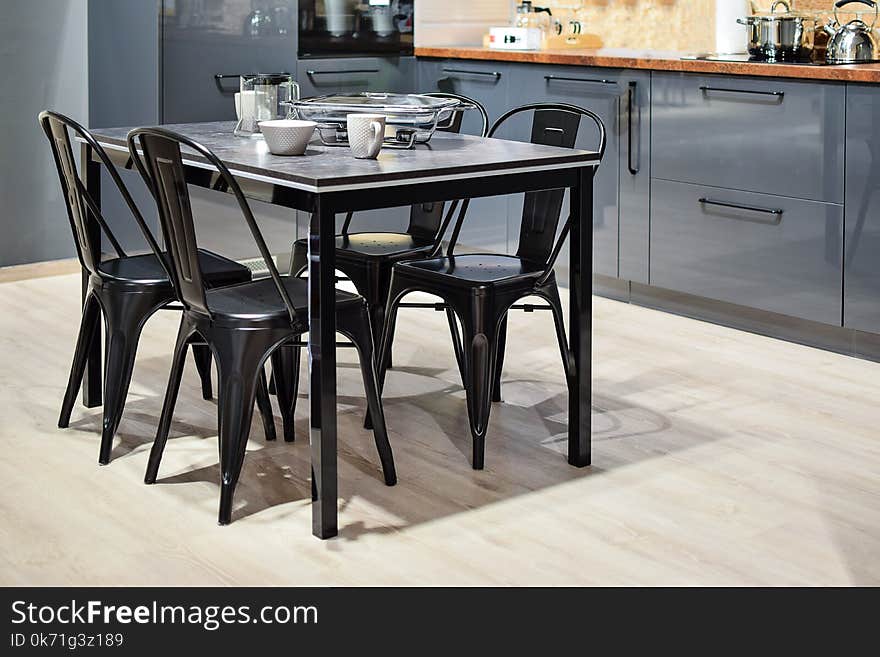 White Ceramic Mug on Black Dining Table With Four Chair Set