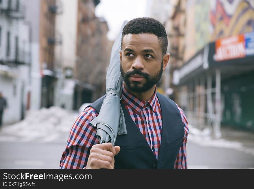 Man Holding Black Umbrella