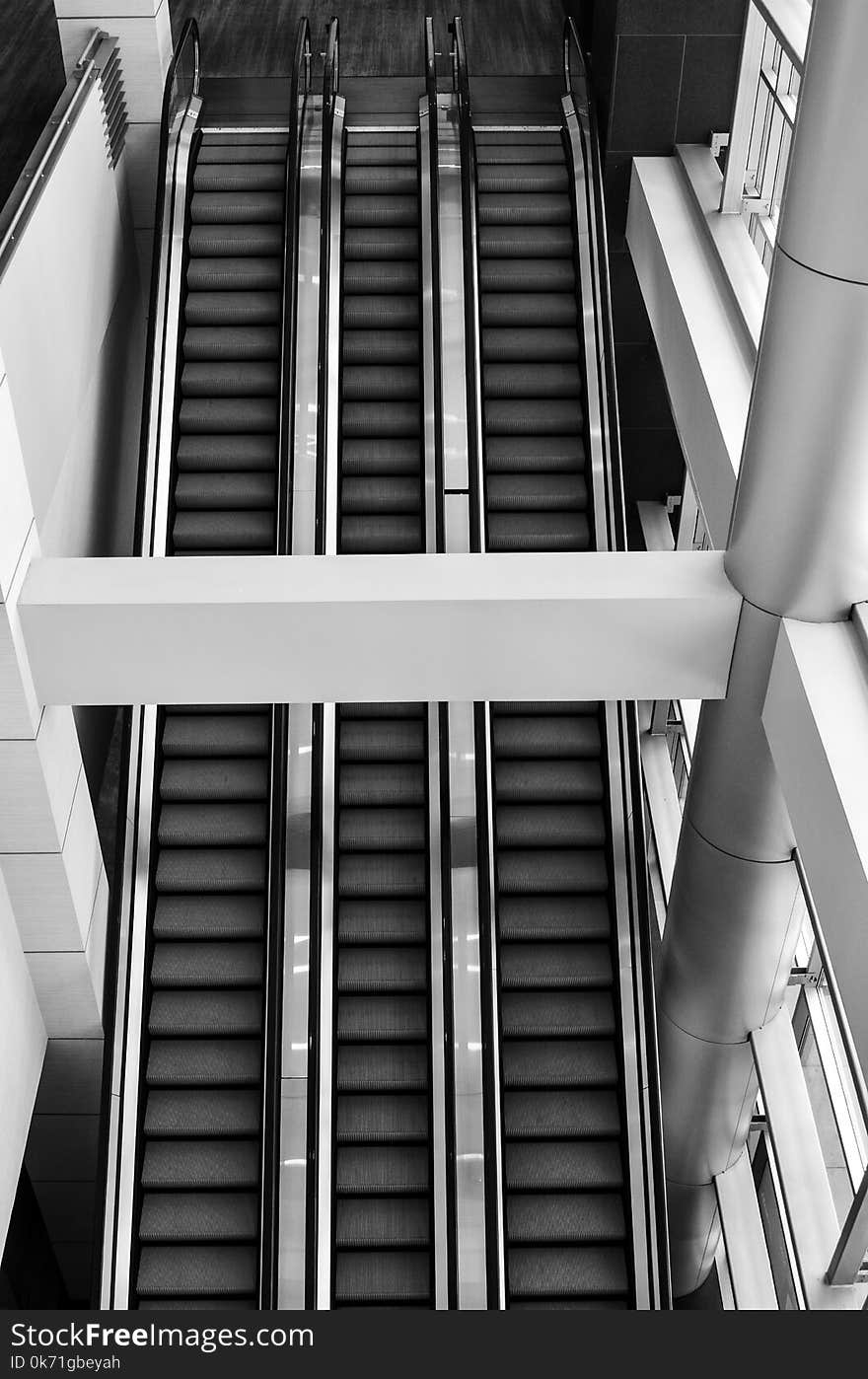 Grayscale Photo of Escalator