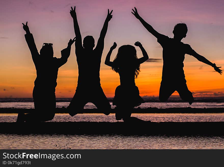 Silhouette of People Jumping