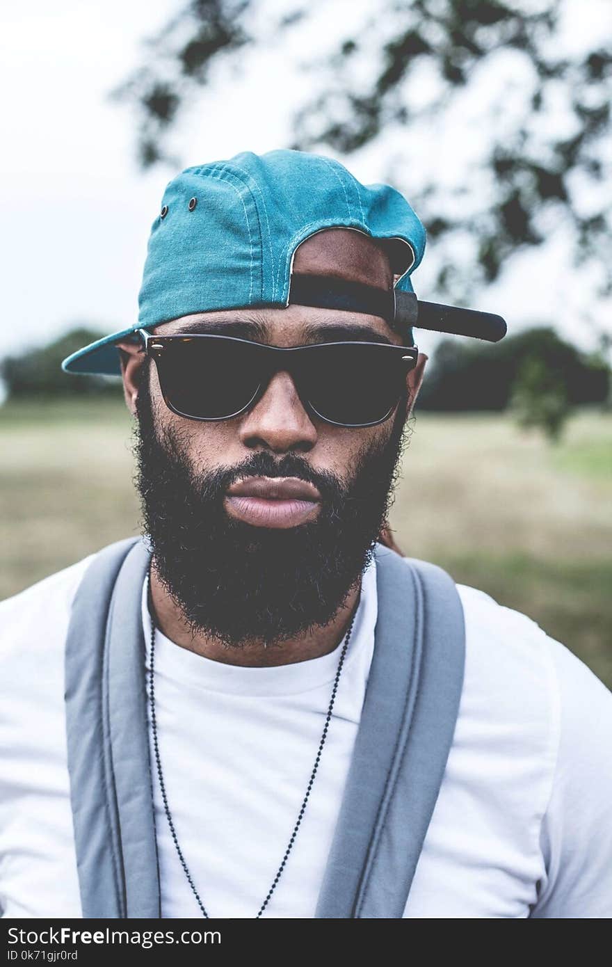 Man Wearing Sunglasses and Denim Strap Back Cap