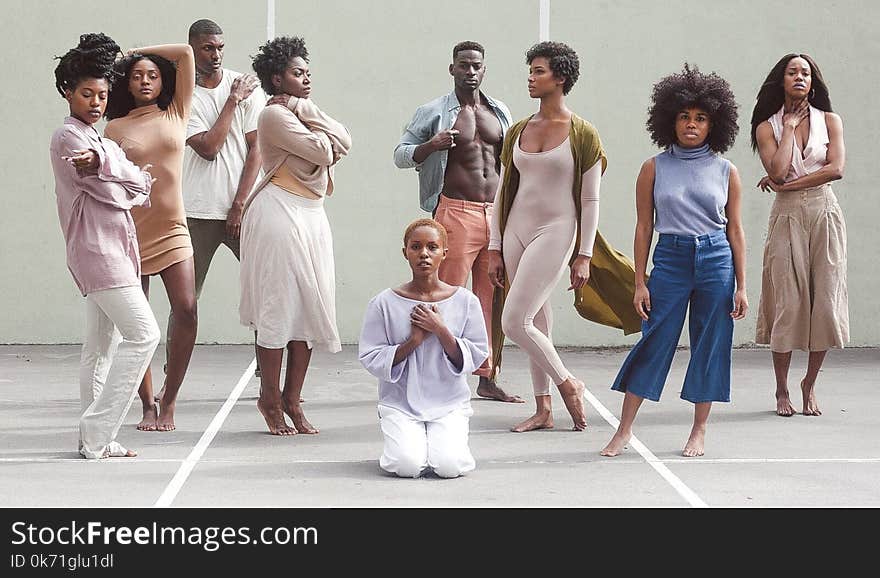 Group of Women and Men Standing on Gray and White Concrete Floor