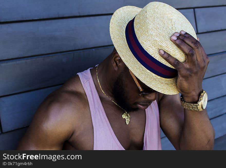 Man Wearing Purple Tank Top, Gold-colored Necklace, Gold-colored Watch, Sunglasses, and Beige Fedora Hat Outfit