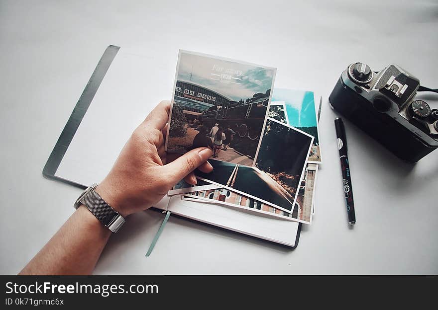 Person Holding Photo Near Camera