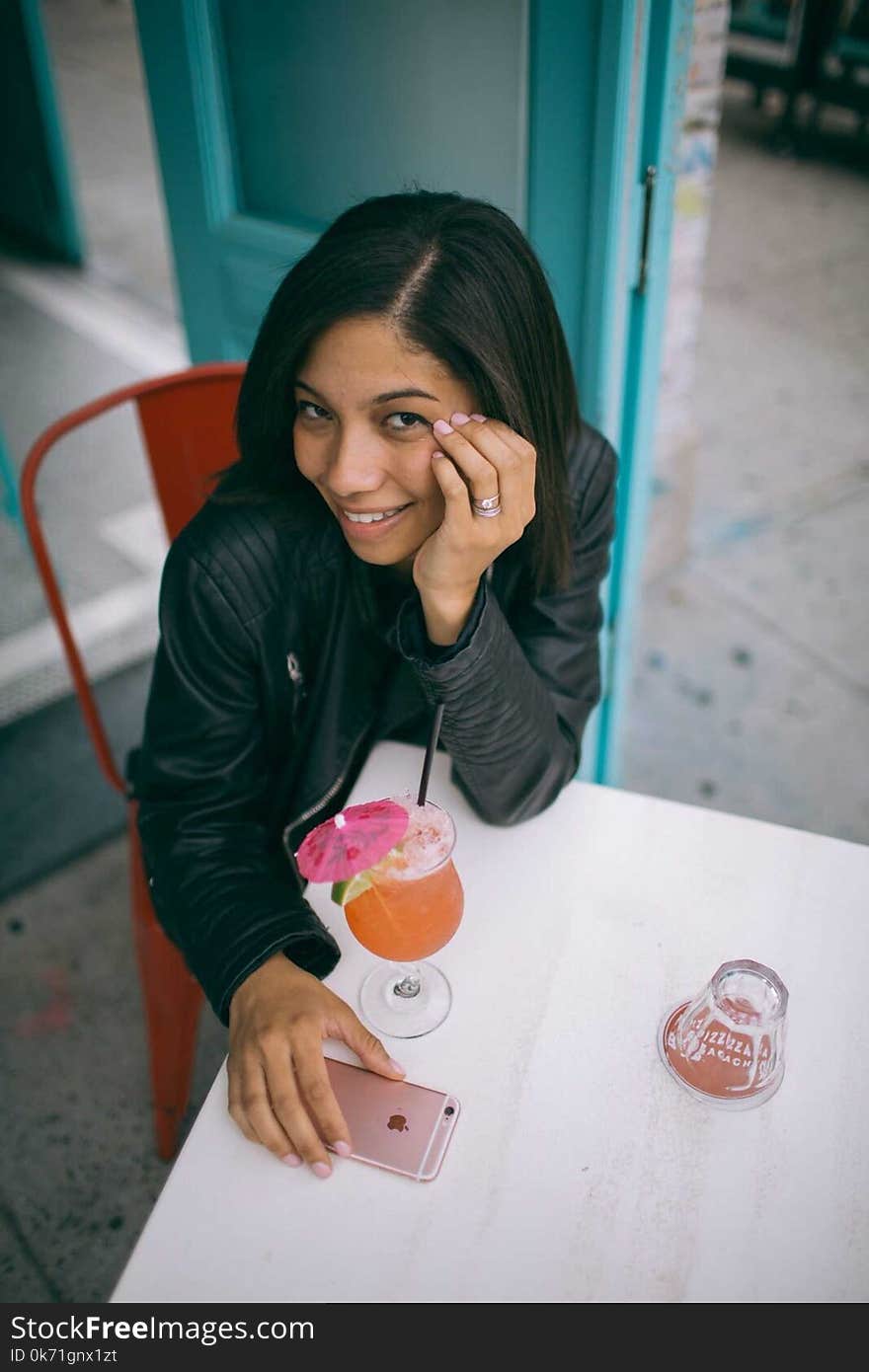 Woman Sitting on Chair With Her Hands Below Her Cheek