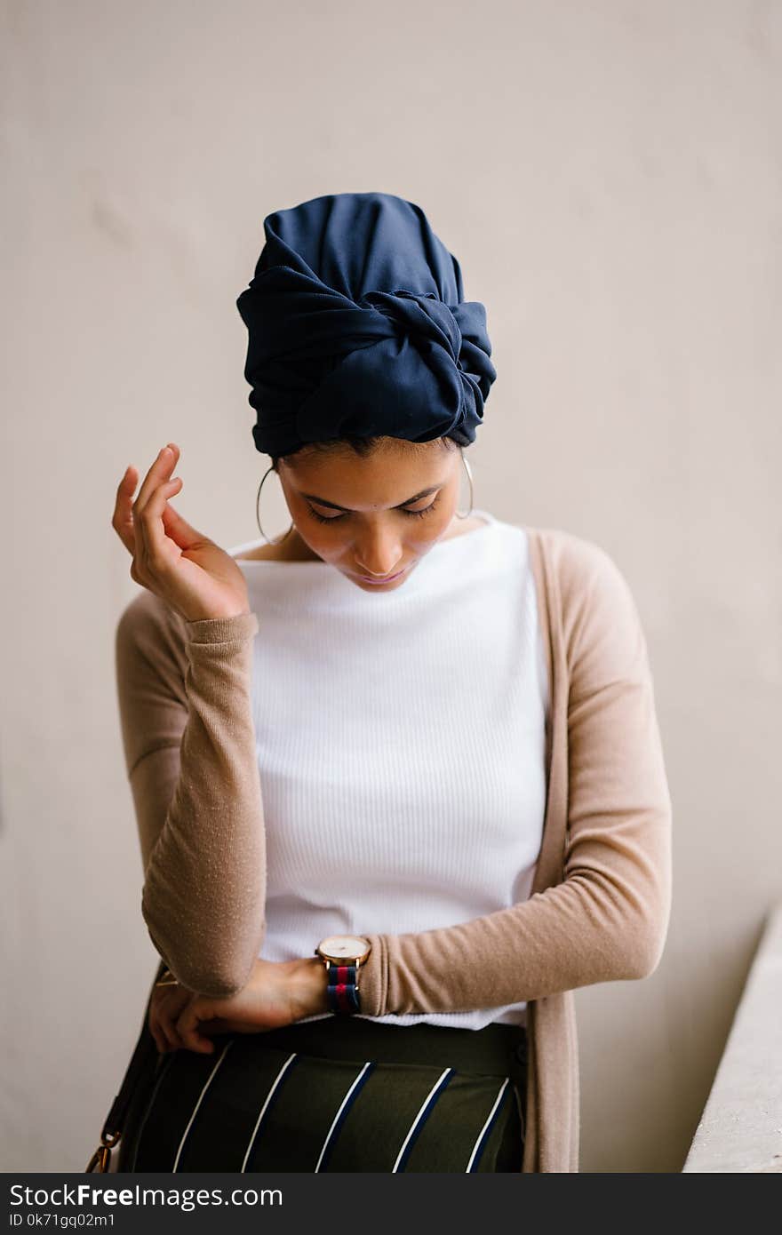 Woman Wearing Blue Turban, White Top and Brown Cardigan