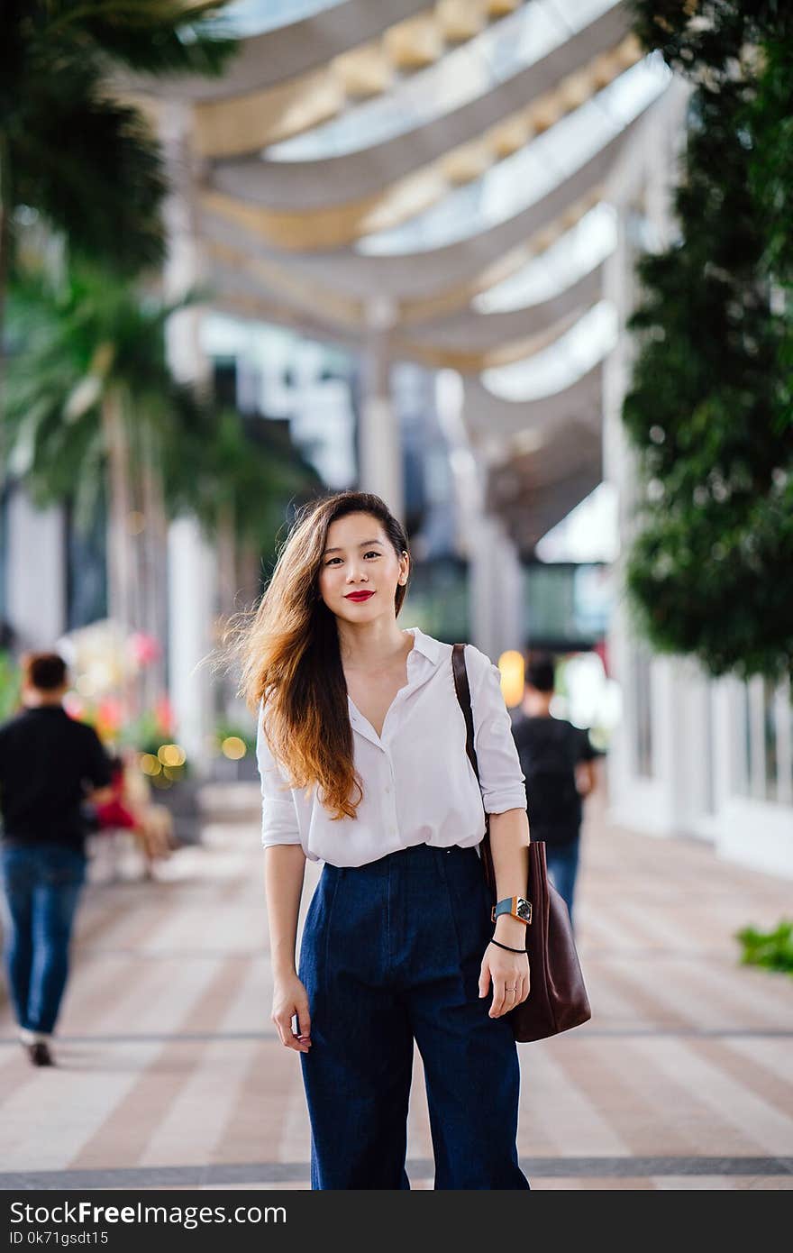 Woman Wearing White Dress Shirt and Blue Pants